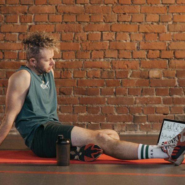 Person smiling and looking serene after a fulfilling workout session.